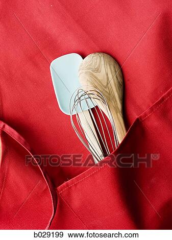 red apron with a spatula, a whisk and a wooden mixing spoon View Large Photo Image Stock Photo - red apron with a spatula, a whisk and a wooden mixing spoon. Fotosearch