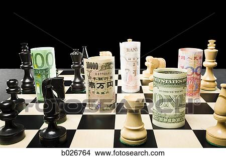 rolled currency on a chess board View Large Photo Image Picture - rolled currency on a chess board. Fotosearch