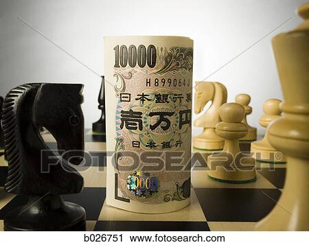 rolled currency on a chess board View Large Photo Image Stock Image - rolled currency on a chess board. Fotosearch