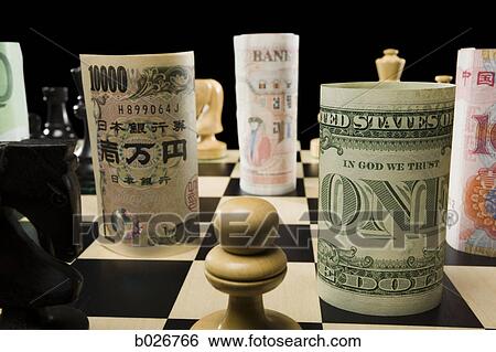 rolled currency on a chess board View Large Photo Image Stock Photograph - rolled currency on a chess board. Fotosearch