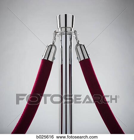 Stock Photograph - rope stand with a velvet rope attached. Fotosearch