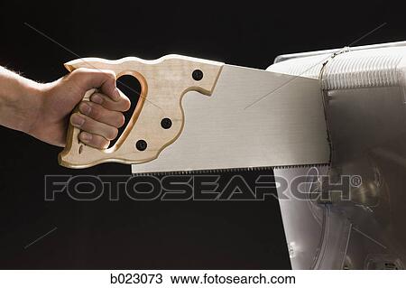 Stock Image - saw cutting a computer monitor. Fotosearch