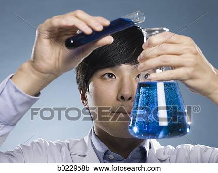 Stock Image - scientist holding test tubes. Fotosearch