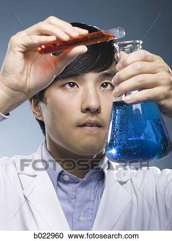 Stock Image - scientist holding test tubes. Fotosearch