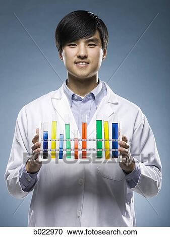 Stock Image - scientist holding test tubes. Fotosearch