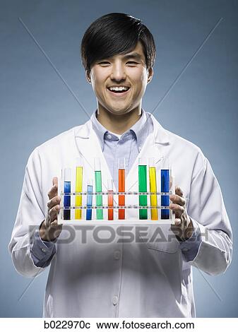 Stock Image - scientist holding test tubes. Fotosearch
