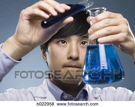 scientist holding test tubes View Large Photo Image Stock Photo - scientist holding test tubes. Fotosearch