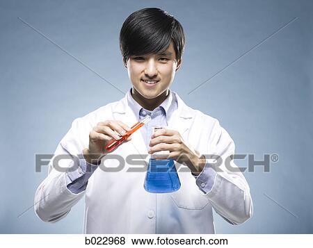 Stock Photo - scientist holding test tubes. Fotosearch