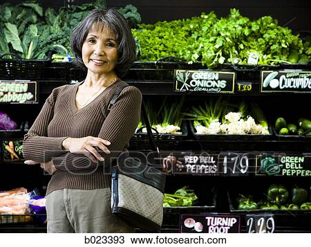 Stock Image - senior woman at the supermarket. Fotosearch
