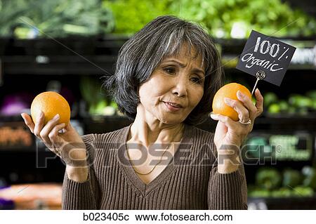 Stock Image - senior woman at the supermarket. Fotosearch