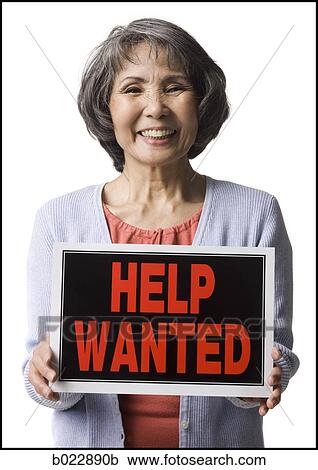 senior woman holding help wanted sign View Large Photo Image Stock Image - senior woman holding help wanted sign. Fotosearch