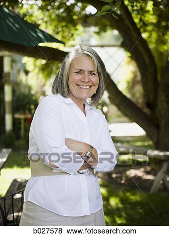 Stock Photo - senior woman in the backyard. Fotosearch