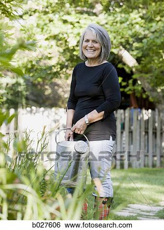 senior woman in the garden View Large Photo Image Stock Photograph - senior woman in the garden. Fotosearch