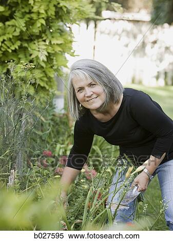 senior woman in the garden View Large Photo Image Stock Photography - senior woman in the garden. Fotosearch