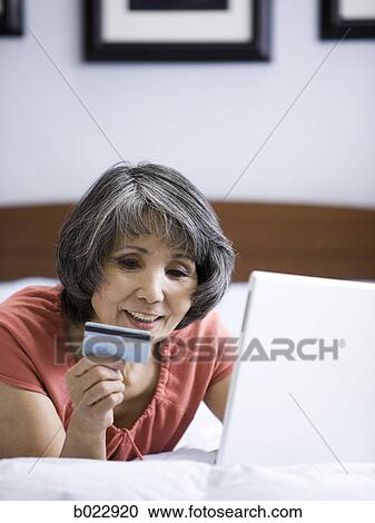senior woman making an online purchase with her credit card View Large Photo Image Stock Image - senior woman making an online purchase with her credit card. Fotosearch