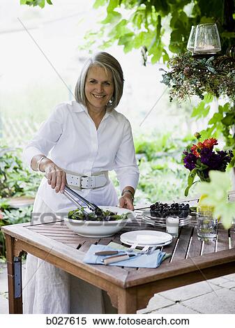 senior woman preparing food outdoors View Large Photo Image Stock Photography - senior woman preparing food outdoors. Fotosearch