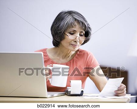 senior woman using a laptop computer View Large Photo Image Picture - senior woman using a laptop computer. Fotosearch