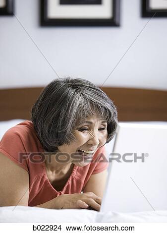 senior woman using a laptop computer View Large Photo Image Picture - senior woman using a laptop computer. Fotosearch