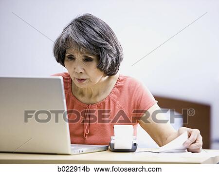 senior woman using a laptop computer View Large Photo Image Stock Image - senior woman using a laptop computer. Fotosearch