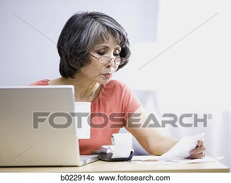 Stock Image - senior woman using a laptop computer. Fotosearch
