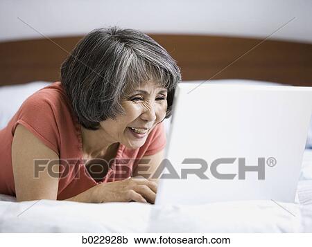 senior woman using a laptop computer View Large Photo Image Stock Image - senior woman using a laptop computer. Fotosearch
