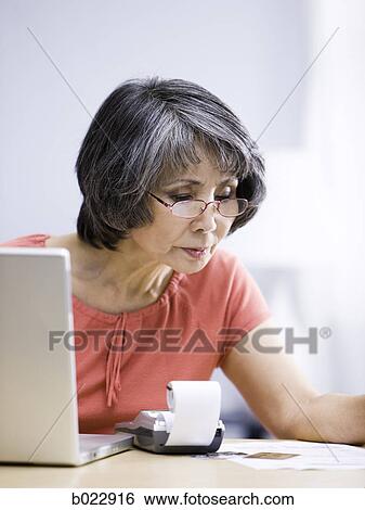 Stock Photograph - senior woman using a laptop computer. Fotosearch