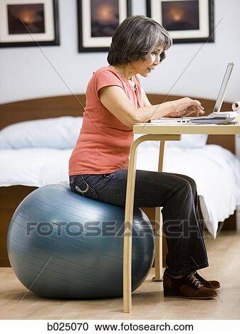 Stock Image - senior woman using a laptop. Fotosearch