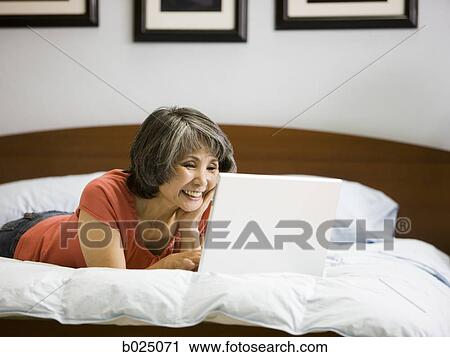 Stock Image - senior woman using a laptop. Fotosearch