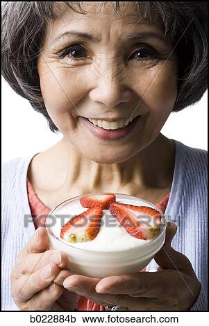 senior woman with a bowl of cereal and strawberries View Large Photo Image Stock Image - senior woman with a bowl of cereal and strawberries. Fotosearch