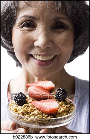 senior woman with a bowl of cereal and strawberries View Large Photo Image Stock Image - senior woman with a bowl of cereal and strawberries. Fotosearch
