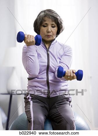 Stock Image - senior woman working out. Fotosearch