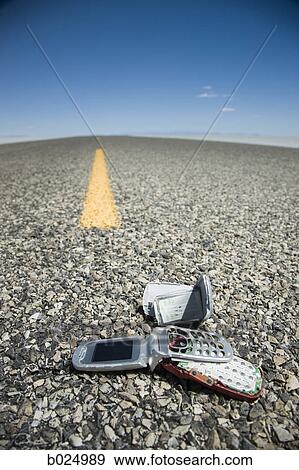 Stock Photo - smashed cell phone on a highway. Fotosearch
