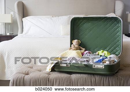 suitcase sitting open on a bed View Large Photo Image Stock Image - suitcase sitting open on a bed. Fotosearch