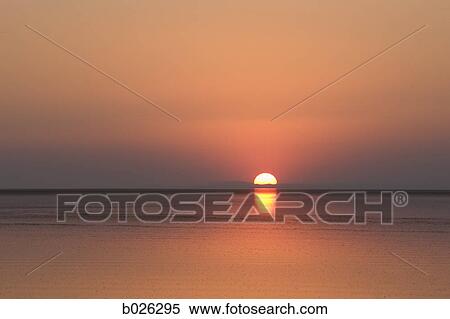 Stock Photography - sunset over the water. Fotosearch