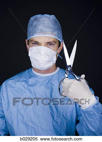 Stock Photography - surgeon holding a pair of scissors. Fotosearch