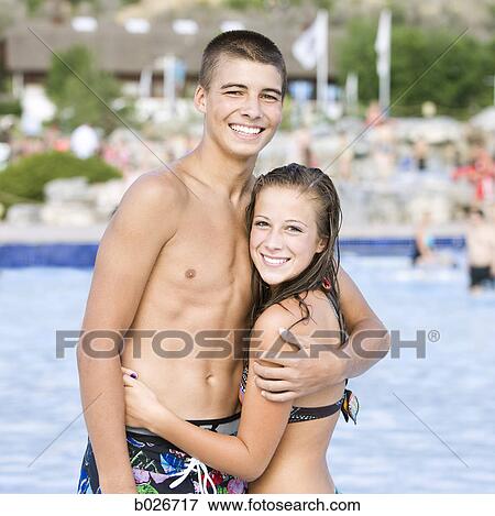 Stock Photo - teenage couple at a waterpark. Fotosearch