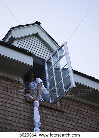 teenager climbing out of her bedroom window View Large Photo Image Picture - teenager climbing out of her bedroom window. Fotosearch