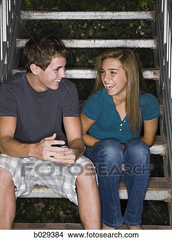 teenagers flirting on a stairway View Large Photo Image Picture - teenagers flirting on a stairway. Fotosearch