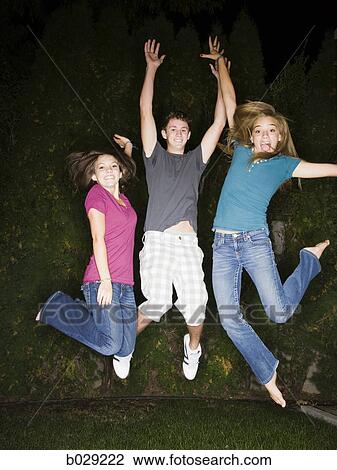 teenagers in a backyard at night View Large Photo Image Stock Image - teenagers in a backyard at night. Fotosearch