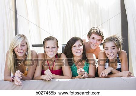 Stock Image - teenagers in a poolside cabana. Fotosearch