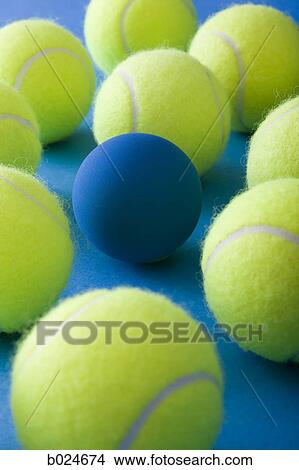 tennis balls and a racquetball against a blue background View Large Photo Image Picture - tennis balls and a racquetball against a blue background. Fotosearch
