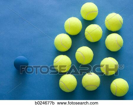 tennis balls and a racquetball against a blue background View Large Photo Image Stock Image - tennis balls and a racquetball against a blue background. Fotosearch