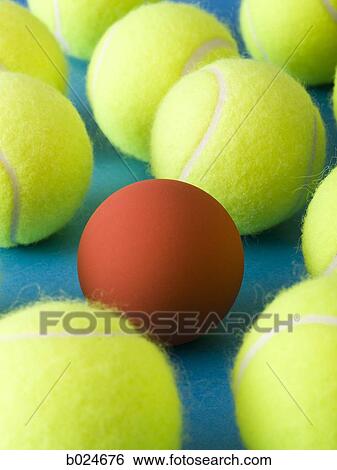 tennis balls and a racquetball against a blue background View Large Photo Image Stock Photograph - tennis balls and a racquetball against a blue background. Fotosearch
