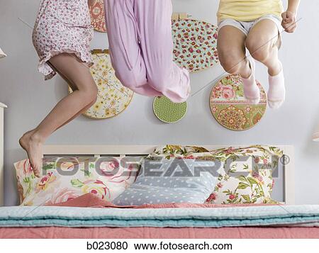 three girls jumping on a bed View Large Photo Image Stock Image - three girls jumping on a bed. Fotosearch