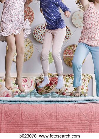 three girls jumping on a bed View Large Photo Image Stock Photo - three girls jumping on a bed. Fotosearch
