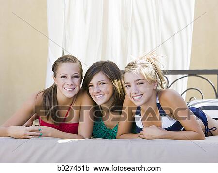 three teenage girls lying in a cabana View Large Photo Image Stock Image - three teenage girls lying in a cabana. Fotosearch