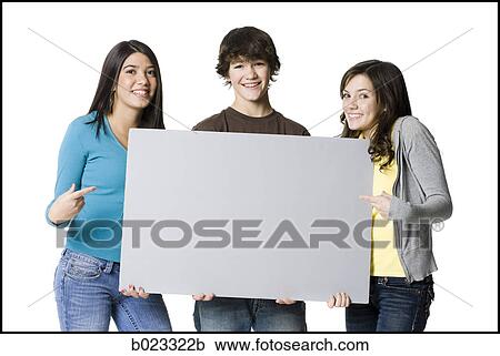 Stock Image - three teenagers holding a sign. Fotosearch