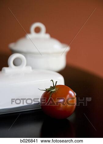 tomato and stoneware on a table View Large Photo Image Stock Image - tomato and stoneware on a table. Fotosearch