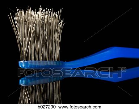 Stock Image - toothbrush with the bristles made of metal wires. Fotosearch