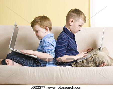 Stock Photo - two boys on laptops. Fotosearch